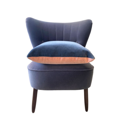 pink and grey cushion cover on grey velvet chair