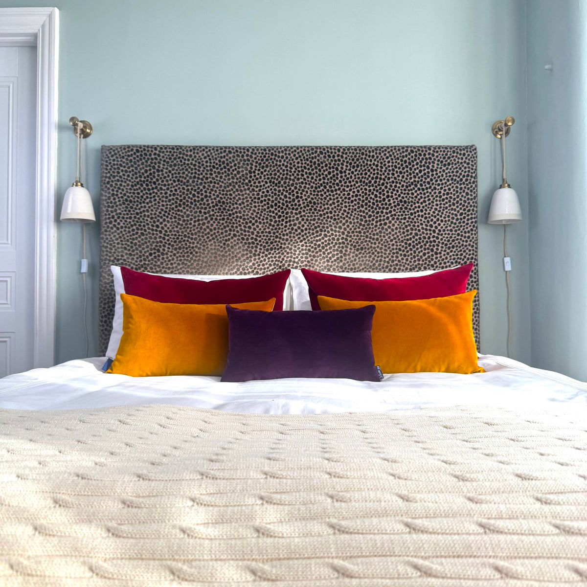 plum velvet cushion in blue room