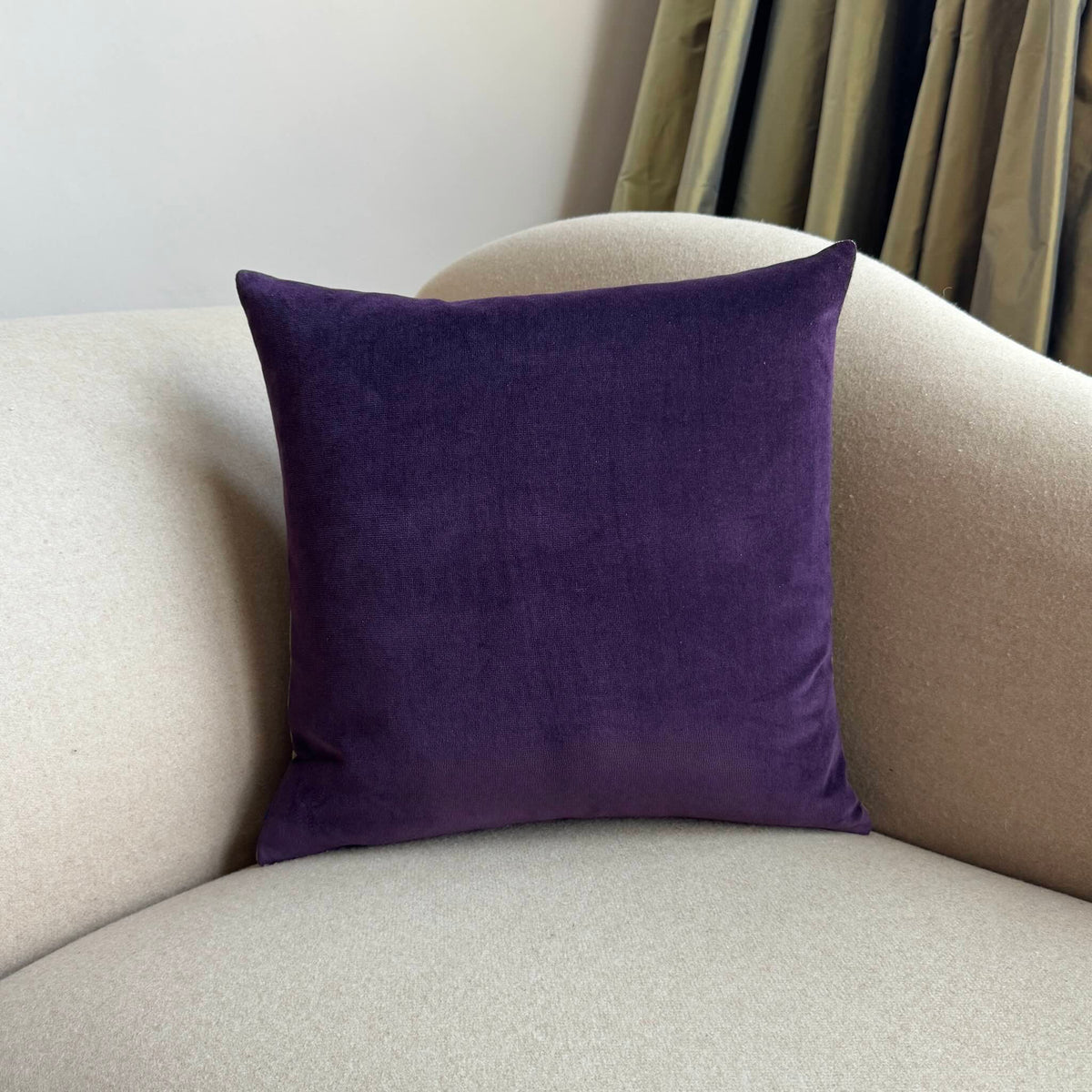 plum velvet cushion square on beige sofa
