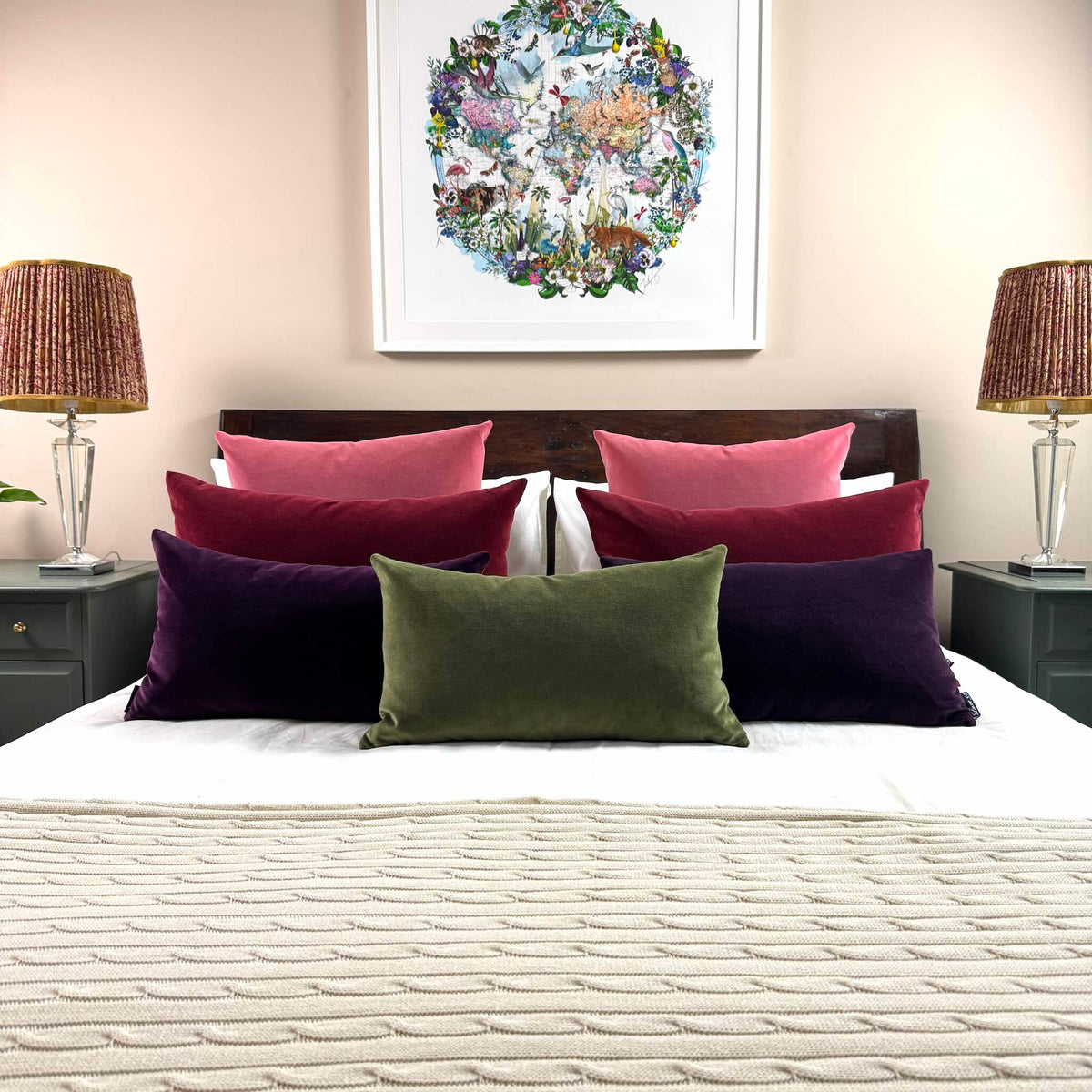 plum velvet cushion with olive, burgundy and rouge on wooden bed