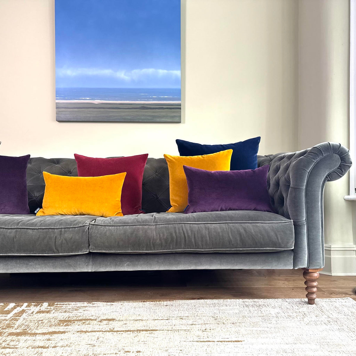 plum velvet cushion cover on grey sofa