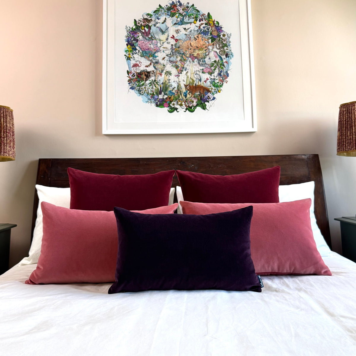 rose pink velvet cushion covers with plum and burgundy on wooden bed