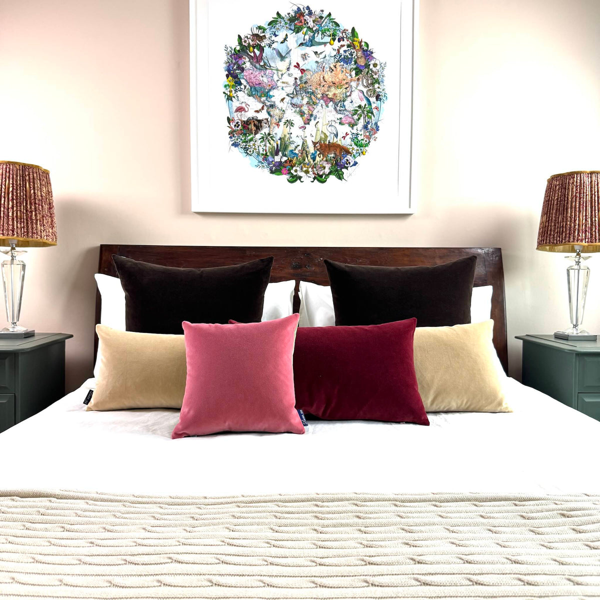 rose pink and burgundy velvet cushions on white bedding on wooden bed