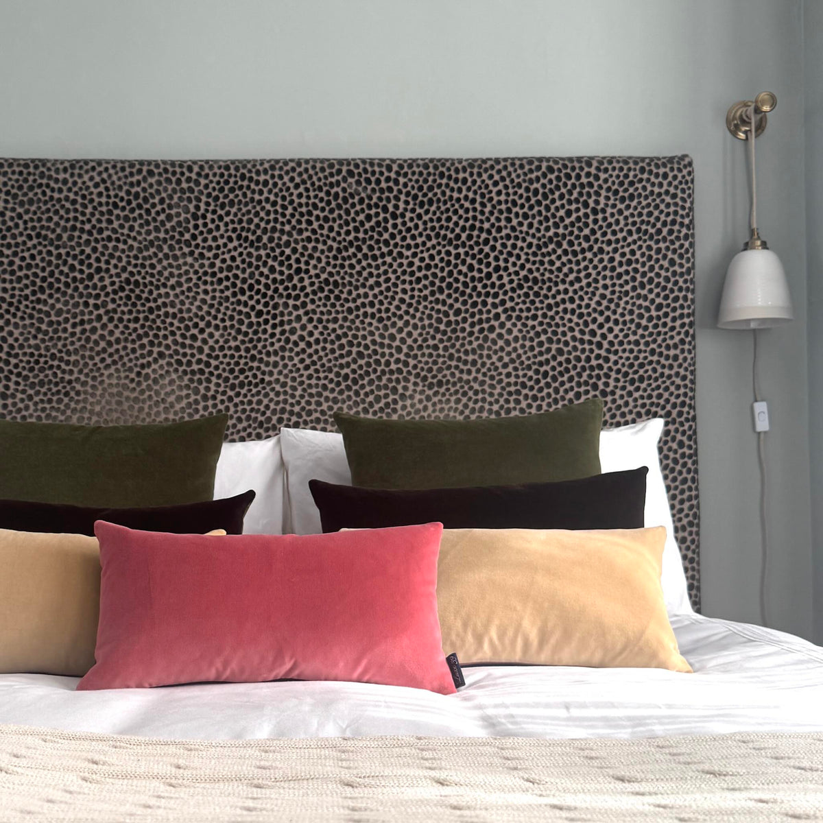 rouge pink velvet cushion with champagne, olive and dark chocolate velvet cushions on white and cream bedding