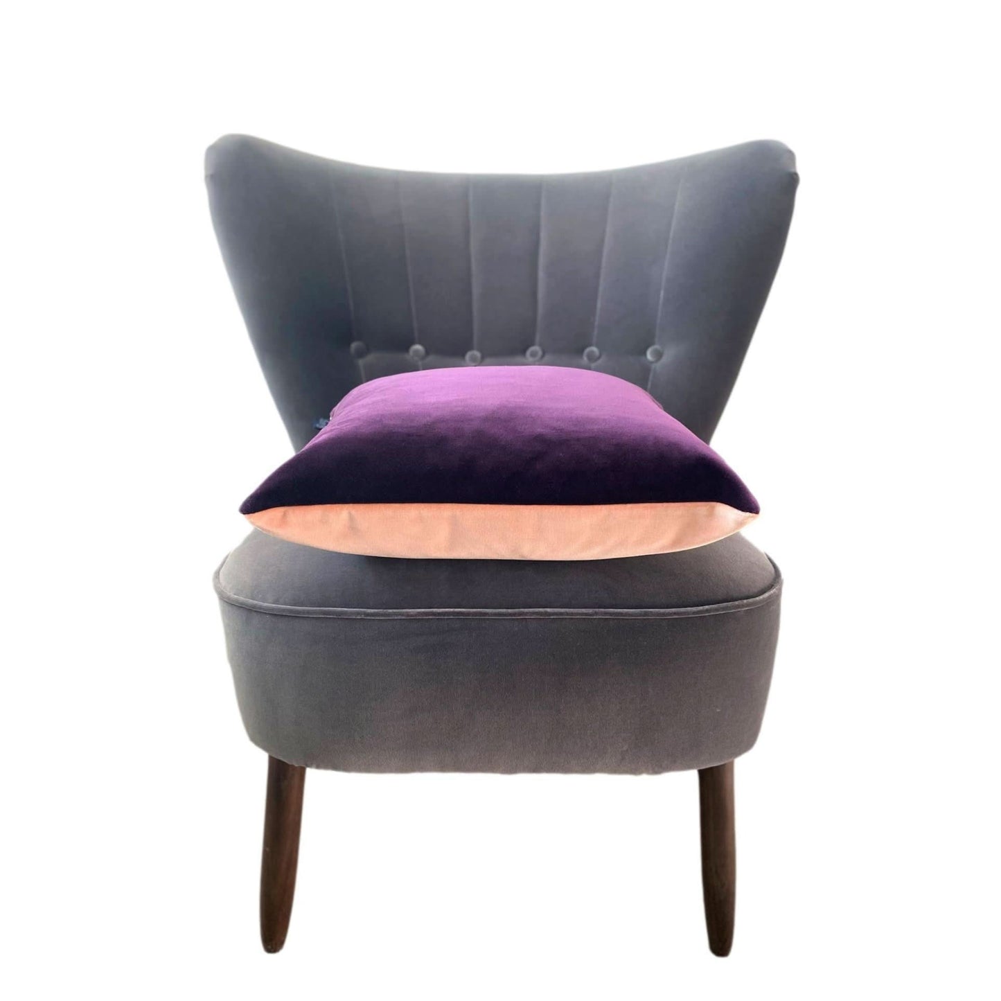 purple and blush pink velvet cushion cover on a dark grey velvet chair