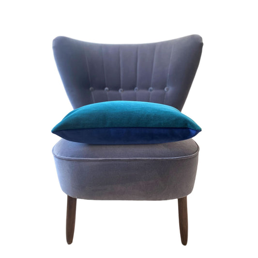 teal velvet cushion with a navy velvet reverse