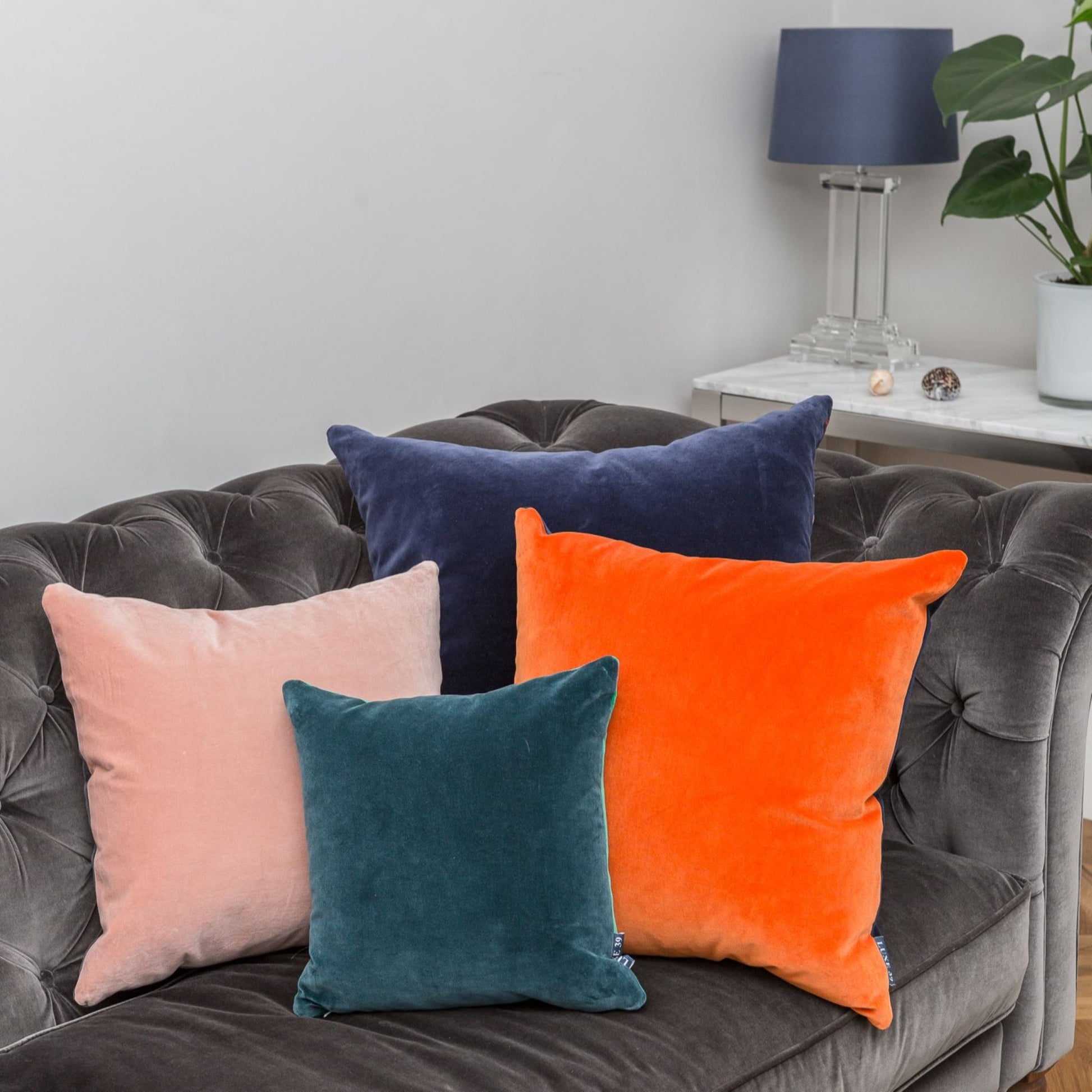 pink fluffy cushions with teal, orange and navy cushions