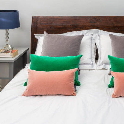 pink fluffy cushions with emerald and silver cushions